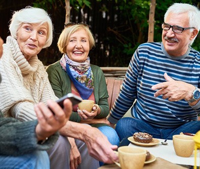 Group of friendly eating outside and chatting