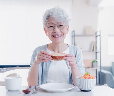 Woman enjoying a nutritious breakfast and smiling