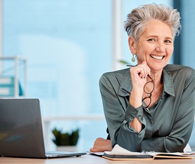 Business professional smiling at her desk
