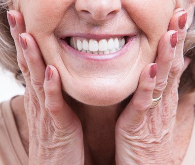 a woman smiling with her dentures on