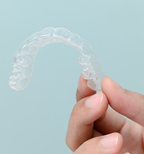 Patient holding clear aligner