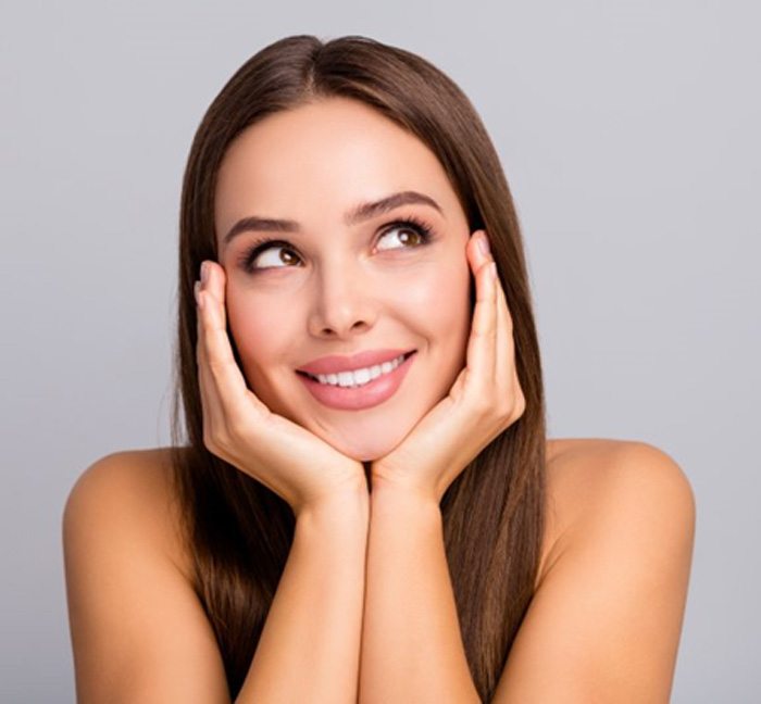 a woman smiling after receiving BOTOX treatment