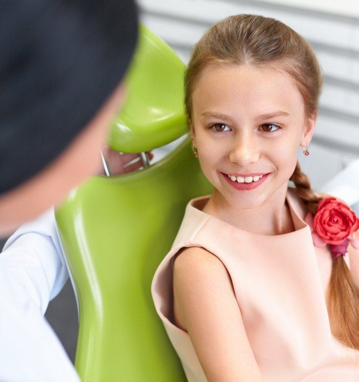 Young girl in dentalc hair smiling at Waverly children's dentist