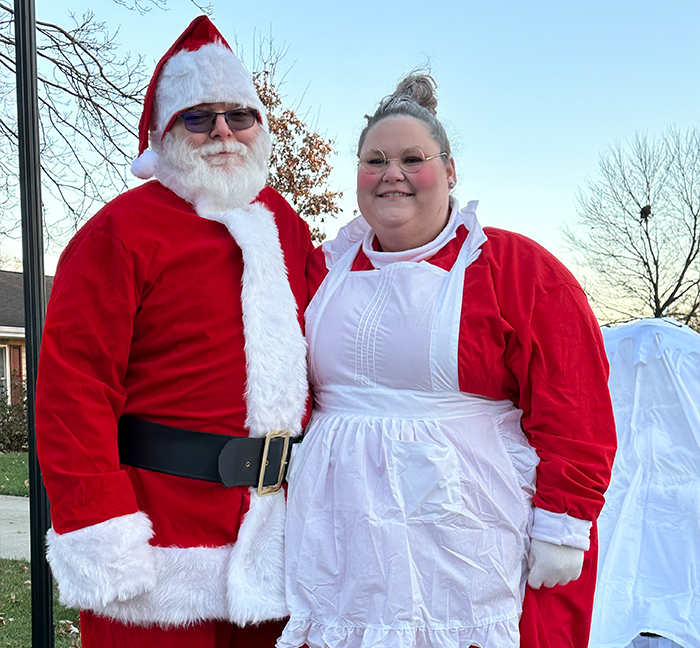 Two people dressed as Santa Claus and Missus Claus
