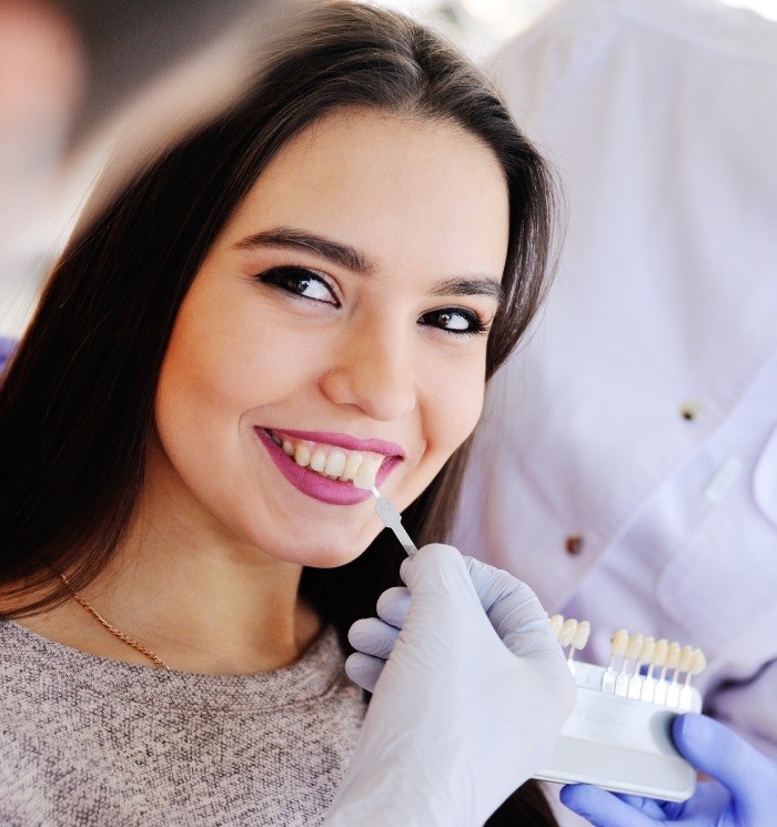 Young woman getting veneers from Waverly cosmetic dentist