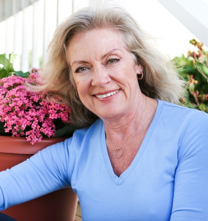 Senior woman in blue blouse smiling
