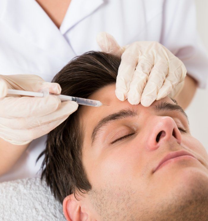 Man getting Botox injection in forehead