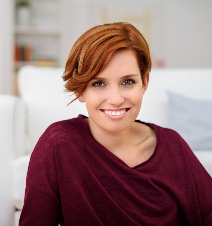 Grinning woman in dark red blouse