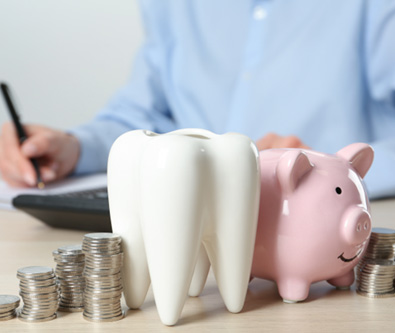 Coins next to a piggy bank