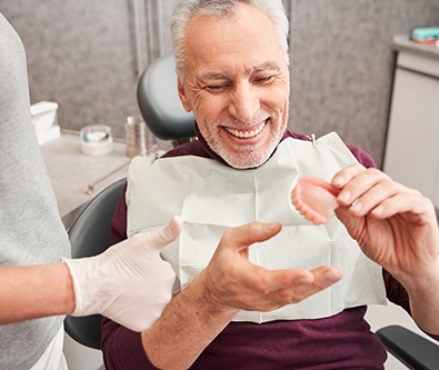 a patient and dentist chatting about dentures
