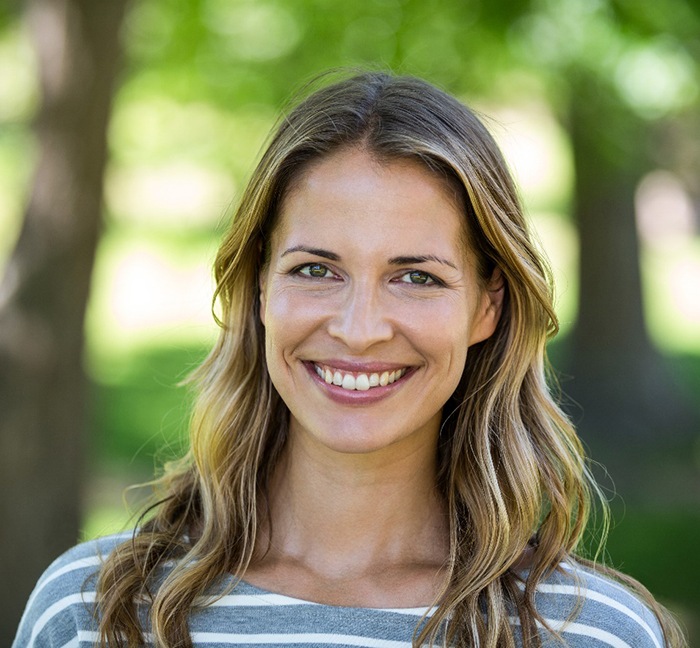 A beautiful woman smiling in an outdoor setting