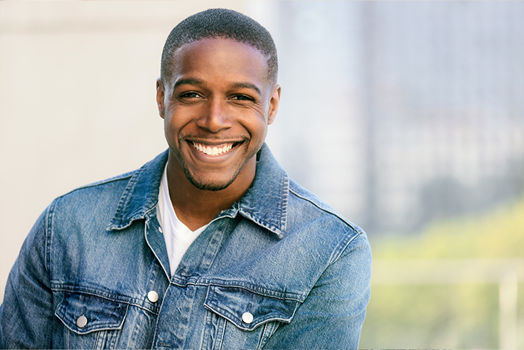 Smiling man in denim jacket