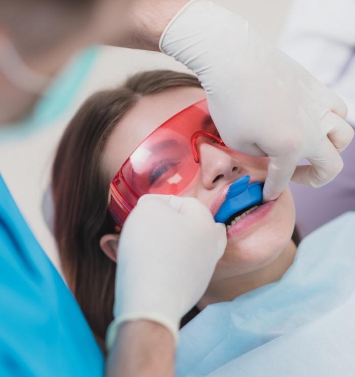 Young woman getting fluoride treatment