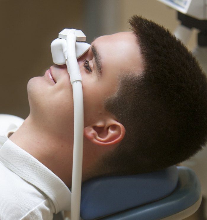 Dental patient laying on back with nitrous oxide mask over his face