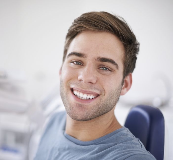 Man in dental chair smiling with SureSmile clear aligners in Waverly