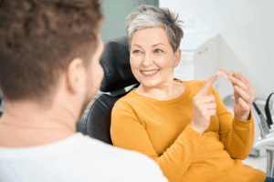 a patient admiring their dentures