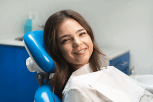 a patient smiling after getting a dental crown